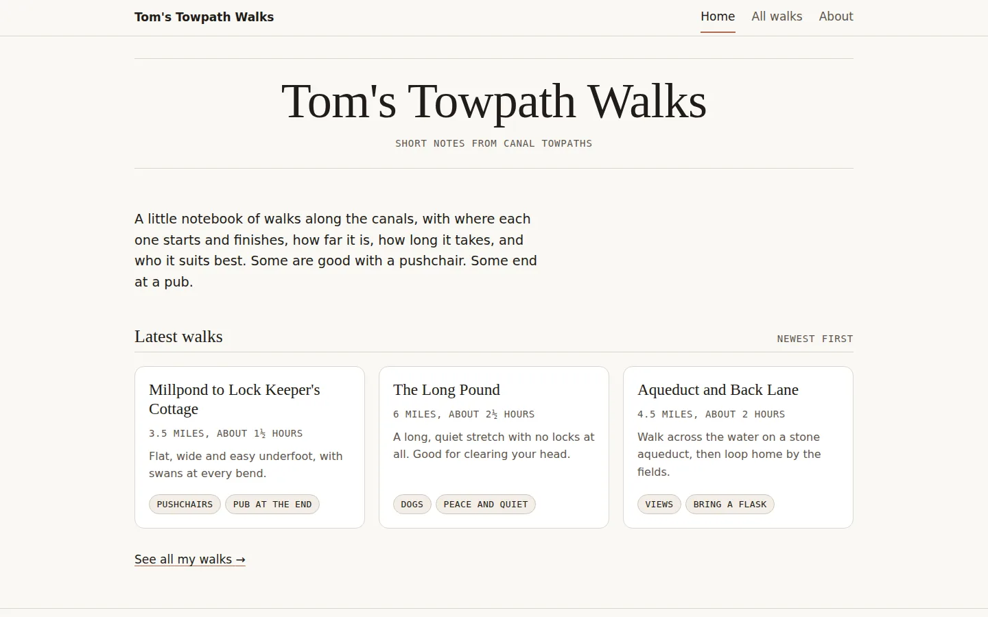 Home page on a laptop: a cream page with a big serif 'Tom's Towpath Walks' heading between thin rules, a short intro, and three walk cards with miles, time and small 'good for' labels.